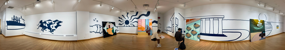 Panoramic view of an art gallery with white walls and wooden floor, featuring large blue murals of an industrial ship, racing greyhounds, a sun with radiating lines, and architectural shapes. Colorful paintings and two seated visitors are visible under bright ceiling lights.