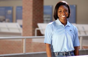 Admissions advisor standing inside a building