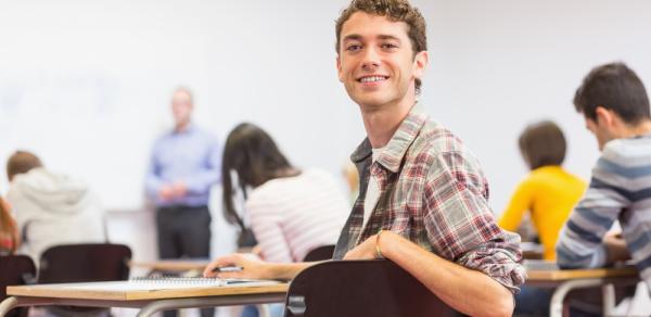 Student smiling in a classroom