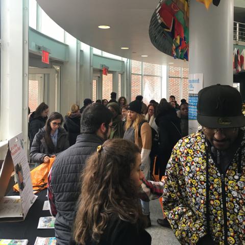 Students, faculty and staff waiting in line to pick up their reusable bag. ​