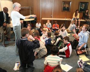 Young Children in a Class Raising Their Hand